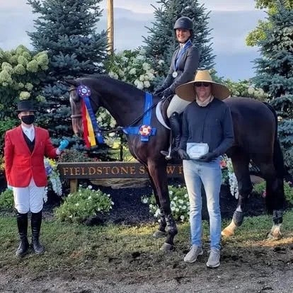 Rider on dark horse with ribbons at Fieldstone Show Park